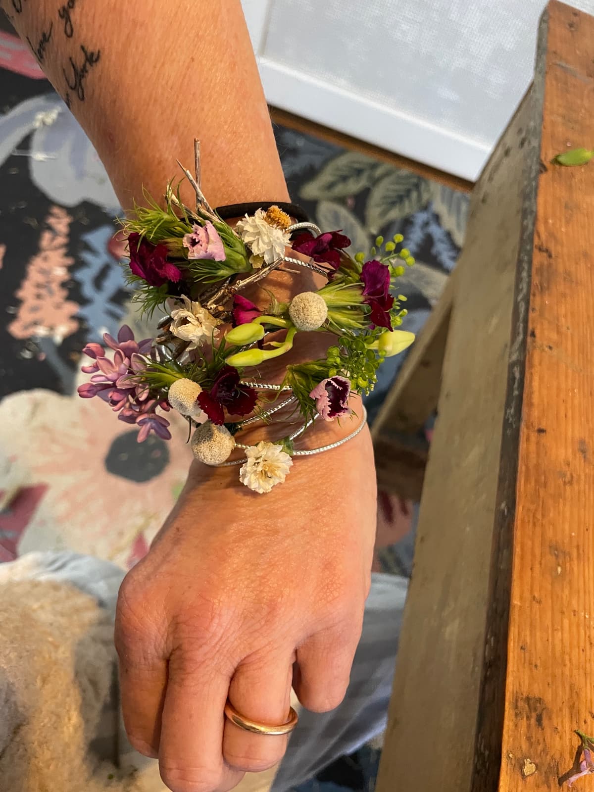 Wrist corsage with burgundy and lavender flowers